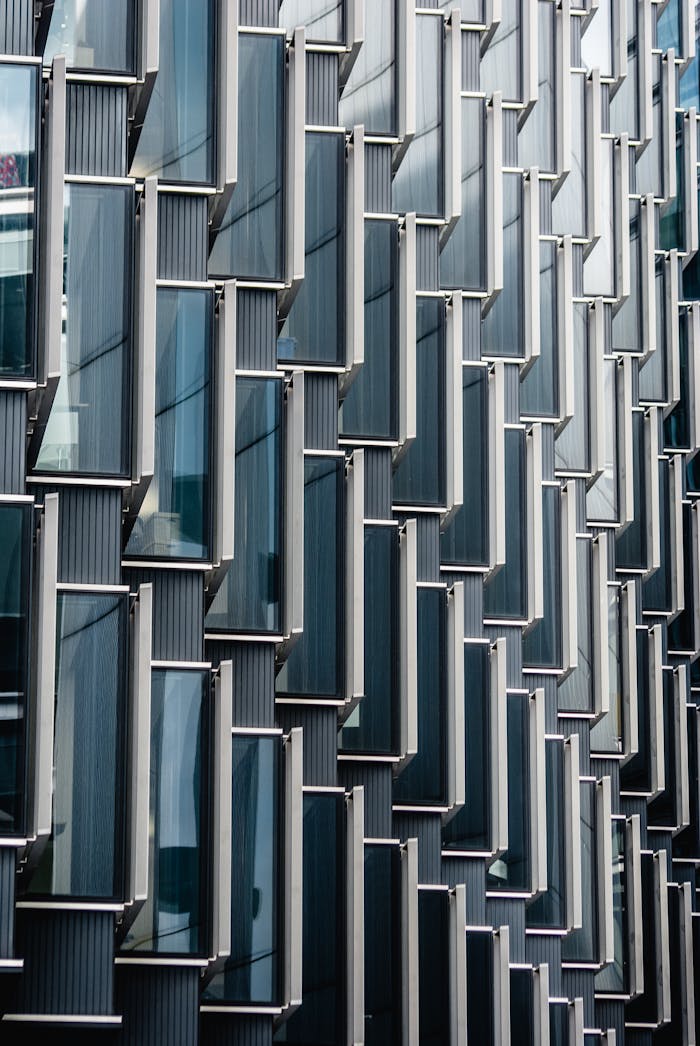 Close-up view of a modern glass and metal building facade showcasing unique geometric patterns in London.